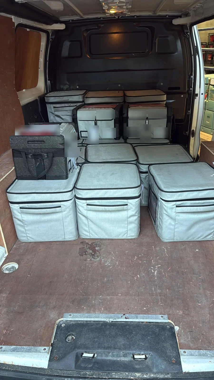 A Red Eagle Logistics courier van loaded with insulated transport boxes ready for an overnight run