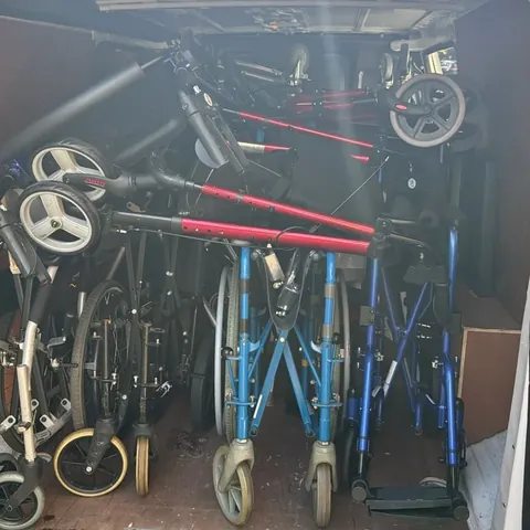 A Red Eagle Logistics van loaded with wheelchairs, rollators and walking frames on a London to Peterborough delivery